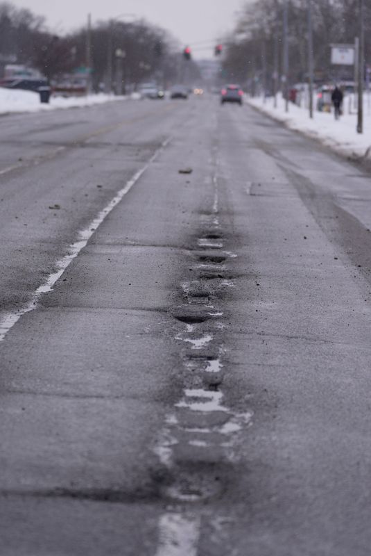Stretches of Monroe Avenue in Brighton on Feb. 24, 2026, has a series of potholes that runs down the line that separates the two lanes heading east towards Twelve Corners..
