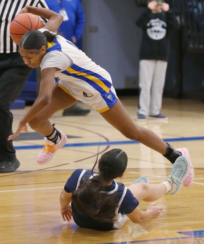 Irondequoit’s London Thomas collides with Thomas’s Julia Romano picking up the offensive foul in the first quarter during their Section V girls basketball sectionals Class AA1 first round game Tuesday, Feb. 24, 2026 at Irondequoit High School.