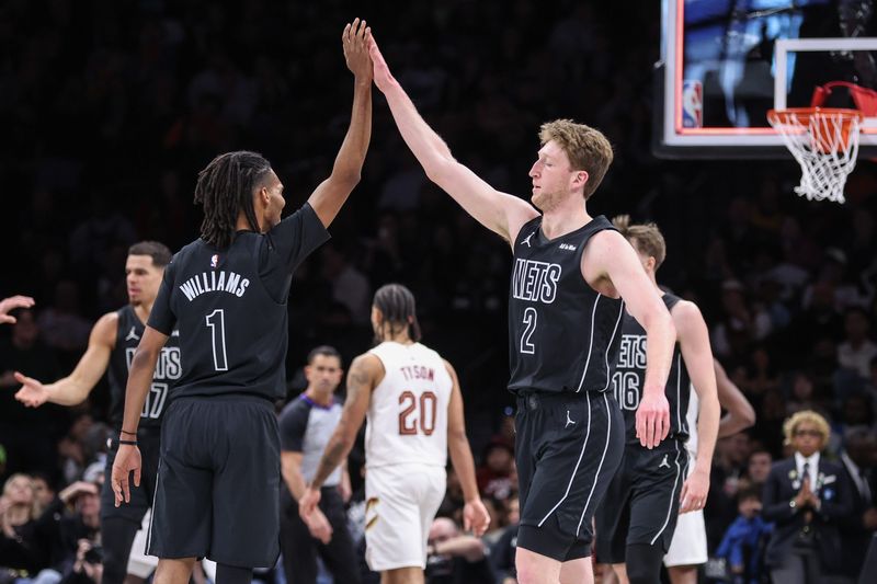 Mar 1, 2026; Brooklyn, New York, USA; Brooklyn Nets forward Ziaire Williams (1) greets forward Danny Wolf (2) after the Cleveland Cavaliers call timeout in the first quarter at Barclays Center. Mandatory Credit: Wendell Cruz-Imagn Images