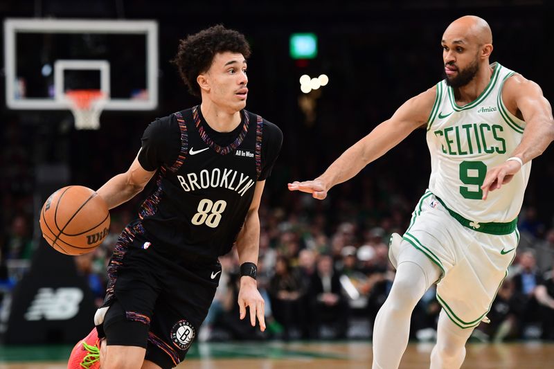 Feb 27, 2026; Boston, Massachusetts, USA; Brooklyn Nets guard Nolan Traore (88) controls the ball while Boston Celtics guard Derrick White (9) defends during the first half at TD Garden. Mandatory Credit: Bob DeChiara-Imagn Images