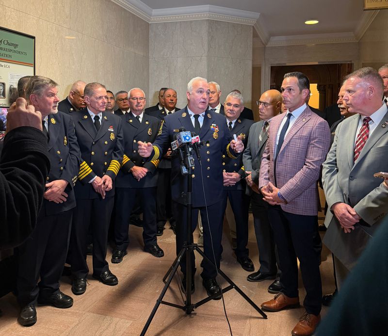 Fire officials from across New York state, including Second Vice President of the Association of Fire Districts Ralph Raymond, center, gathered at the State Capitol on Wednesday, March 4, to push for compensation for volunteer firefighters statewide.