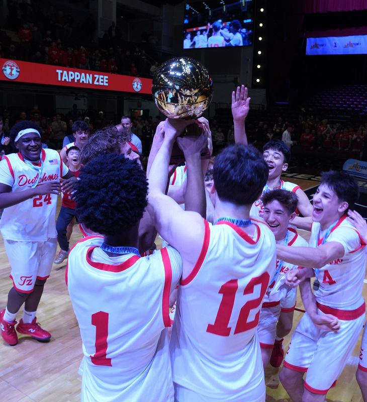 Tappan Zee players celebrate with the Gold Ball after defeating Byram Hills in the Section 1 boys basketball championship game at the Westchester County Center in White Plains March 6, 2026.