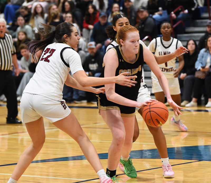 Corning's Charlise Starns is defended by Elmira's Meya Smith as the Hawks beat Elmira, 58-48, in the Section 4 Class AAA girls basketball championship game March 6, 2026 at Watkins Glen High School.
