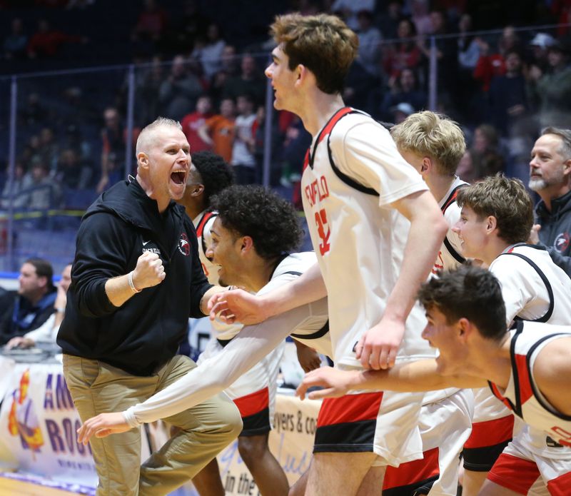 Penfield head coach Jason Ellis leads the celebration as the final buzzer sounds giving the Patriots the win over Victor during their Section V Class AA1 boys basketball sectional finals Saturday, March 7, 2026 at Blue Cross Arena in Rochester.