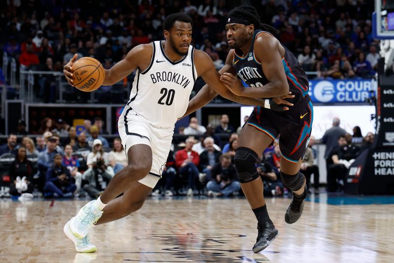 Mar 7, 2026; Detroit, Michigan, USA; Brooklyn Nets center Day'ron Sharpe (20) dribbles defended by Detroit Pistons forward Isaiah Stewart (28) in the first half at Little Caesars Arena. Mandatory Credit: Rick Osentoski-Imagn Images