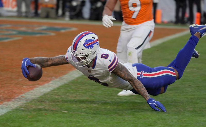 Buffalo Bills wide receiver Keon Coleman after getting tripped up stumbles towards the end zone and gets the ball into the end zone before hitting the ground for a touchdown during second-half action at Empower FIeld at Mile High in Denver on Jan. 17, 2026.