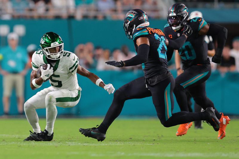 Sep 29, 2025; Miami Gardens, Florida, USA; New York Jets wide receiver Garrett Wilson (5) makes a catch against Miami Dolphins free safety Minkah Fitzpatrick (29) during the first half at Hard Rock Stadium. Mandatory Credit: Sam Navarro-Imagn Images