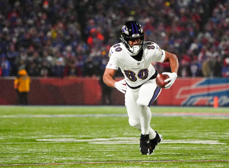 Jan 19, 2025; Orchard Park, New York, USA; Baltimore Ravens tight end Isaiah Likely (80) runs the ball after making a catch during the first quarter against the Buffalo Bills in a 2025 AFC divisional round game at Highmark Stadium. Mandatory Credit: Gregory Fisher-Imagn Images