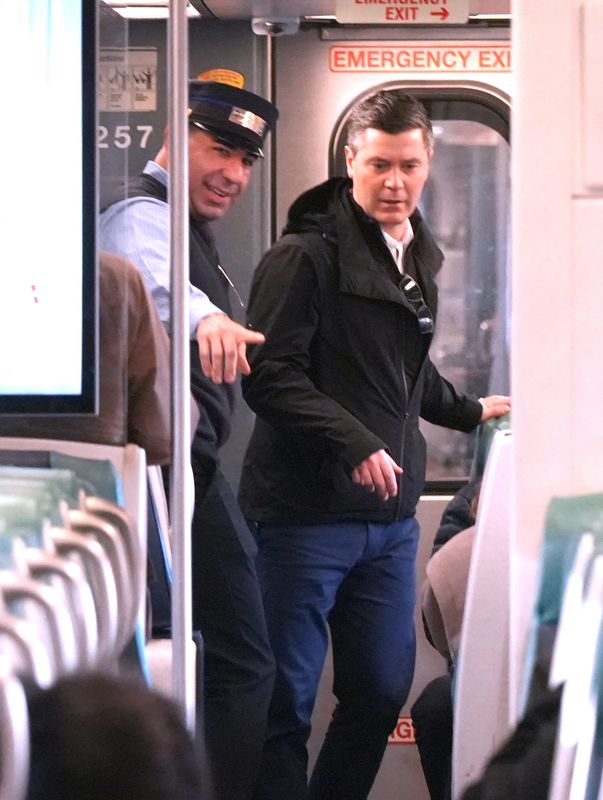 Metro-North conductor Anthony Aprea helps a passenger on a train headed to Manhattan from Hartsdale March 9, 2026.