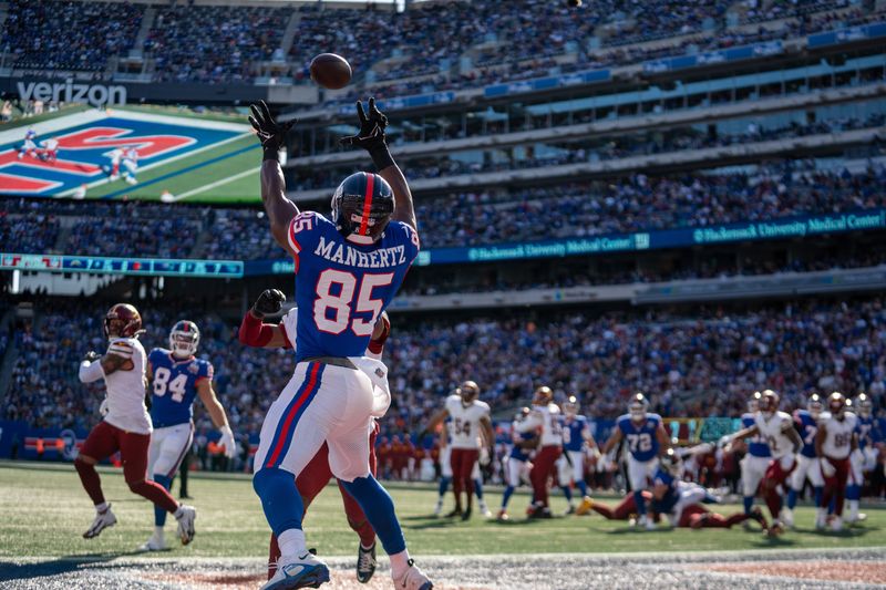 New York Giants tight end Chris Manhertz (85) catches a pass for a touchdown in the second quarter during a game between the New York Giants and the Washington Commanders at MetLife Stadium in East Rutherford on Sunday, Nov. 3, 2024.