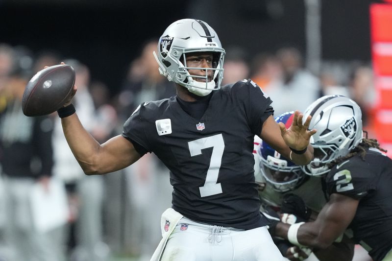 Dec 28, 2025; Paradise, Nevada, USA; Las Vegas Raiders quarterback Geno Smith (7) throws in the third quarter against the New York Giants at Allegiant Stadium. Mandatory Credit: Kirby Lee-Imagn Images