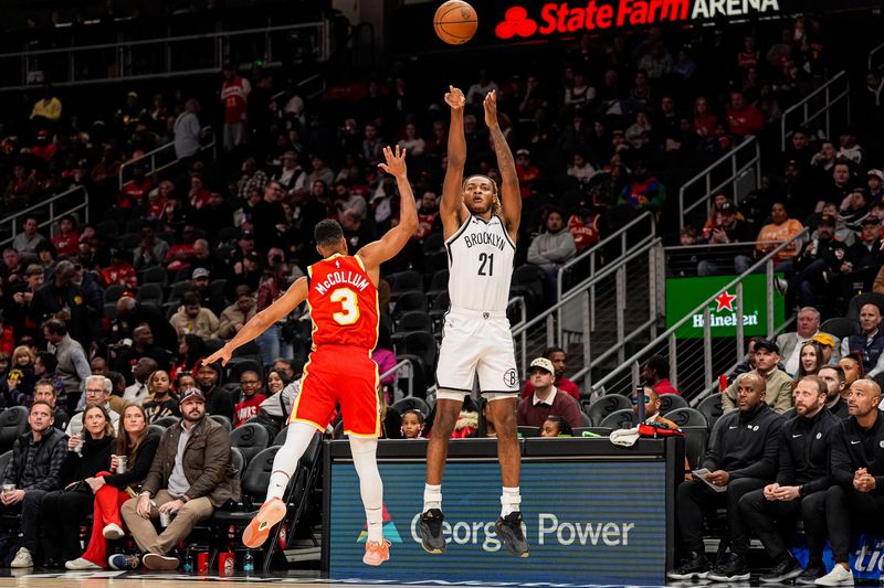 Feb 22, 2026; Atlanta, Georgia, USA; Brooklyn Nets forward Noah Clowney (21) shoots over Atlanta Hawks guard CJ McCollum (3) during the first half at State Farm Arena. Mandatory Credit: Dale Zanine-Imagn Images