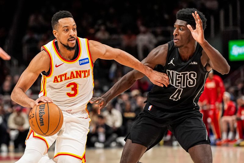 Mar 12, 2026; Atlanta, Georgia, USA; Atlanta Hawks guard CJ McCollum (3) dribbles against Brooklyn Nets guard Drake Powell (4) during the second half at State Farm Arena. Mandatory Credit: Dale Zanine-Imagn Images