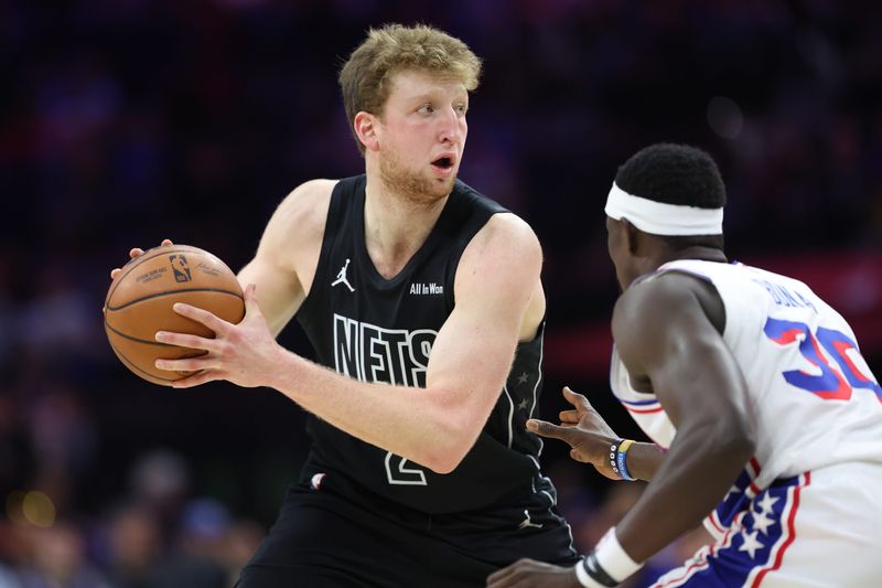 Mar 14, 2026; Philadelphia, Pennsylvania, USA; Brooklyn Nets forward Danny Wolf (2) controls the ball against Philadelphia 76ers center Adem Bona (30) during the second quarter at Xfinity Mobile Arena. Mandatory Credit: Bill Streicher-Imagn Images