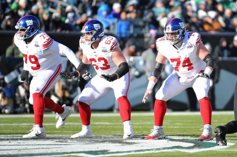 Jan 5, 2025; Philadelphia, Pennsylvania, USA; New York Giants offensive tackle Tyre Phillips (79), guard Jake Kubas (63) and guard Greg Van Roten (74) against the Philadelphia Eagles at Lincoln Financial Field. Mandatory Credit: Eric Hartline-Imagn Images