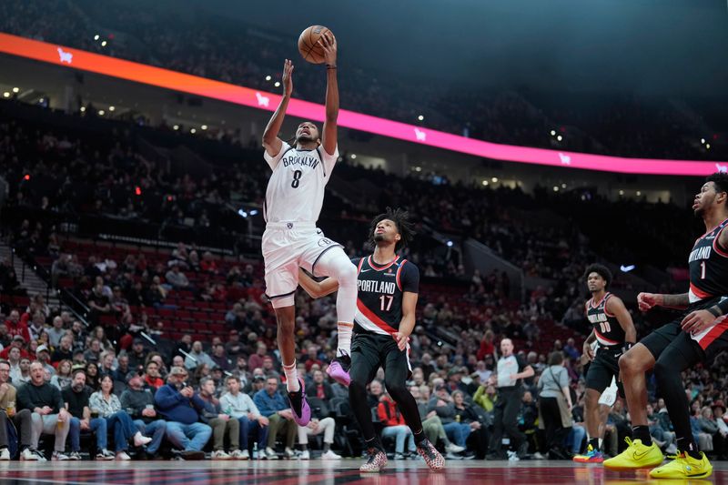 Jan 14, 2025; Portland, Oregon, USA; Brooklyn Nets forward Ziaire Williams (8) goes up for a dunk as Portland Trail Blazers shooting guard Shaedon Sharpe (17) looks on during the first half at Moda Center. Mandatory Credit: Soobum Im-Imagn Images