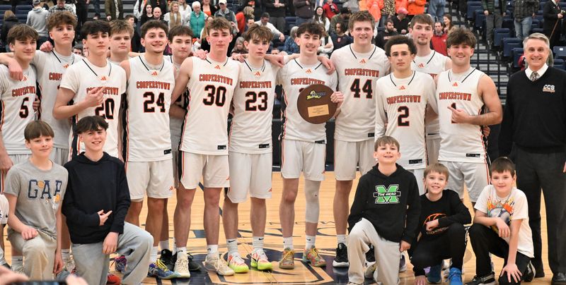 The Cooperstown Hawkeyes pose with their regional plaque after defeating Section IV Elmira-Notre Dame Sunday at SRC Arena in Syracuse.