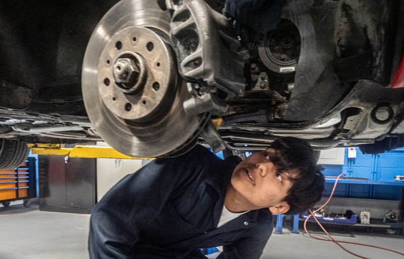 Fernando Jimenez Ramirez, a junior at New Rochelle High School and a student in the Southern Westchester BOCES Automotive Technology program, examines a wheel as he and fellow students prepare to replace the breaks on a vehicle at the BOCES campus in Valhalla March 16, 2026. Fernando is one of twenty-four New Rochelle juniors and seniors involved in the two year program. Students graduate from the automotive program with ASE (Automotive Service Excellence) certification in eight major automotive areas. They are also eligible are for college credits at certain colleges if they meet certain criteria.