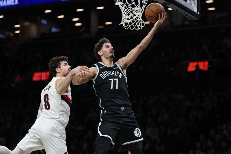 Mar 16, 2026; Brooklyn, New York, USA; Brooklyn Nets guard Ben Saraf (77) goes to the basket as Portland Trail Blazers forward Deni Avdija (8) defends during the second half at Barclays Center. Mandatory Credit: Vincent Carchietta-Imagn Images