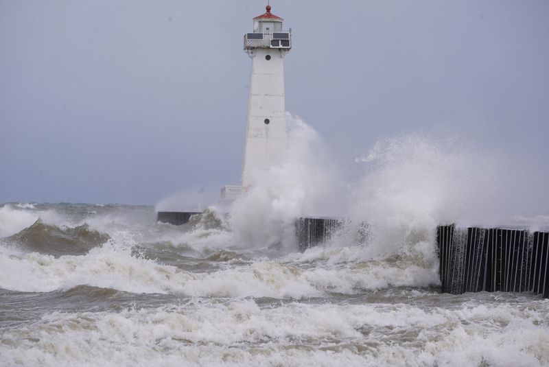 Waves crash into the Sodus Point lighthouse in Sodus Point on March 16, 2026. The area has been under a high wind warning since Monday.
