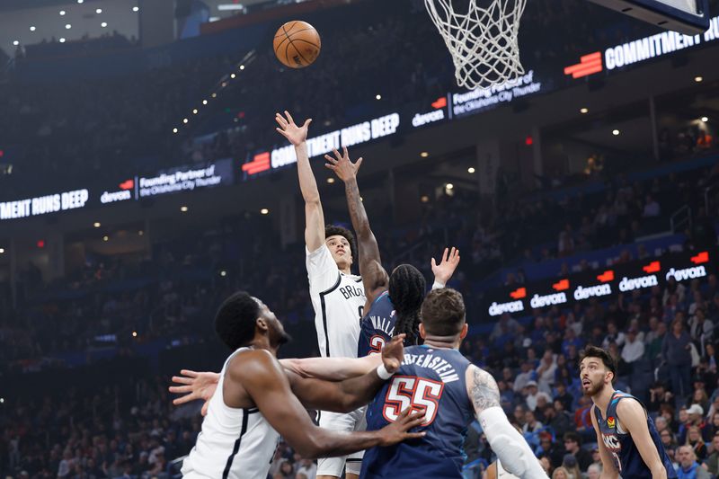 Feb 20, 2026; Oklahoma City, Oklahoma, USA; Brooklyn Nets guard Nolan Traore (88) shoots over Oklahoma City Thunder guard Cason Wallace (22) during the first quarter at Paycom Center. Mandatory Credit: Alonzo Adams-Imagn Images