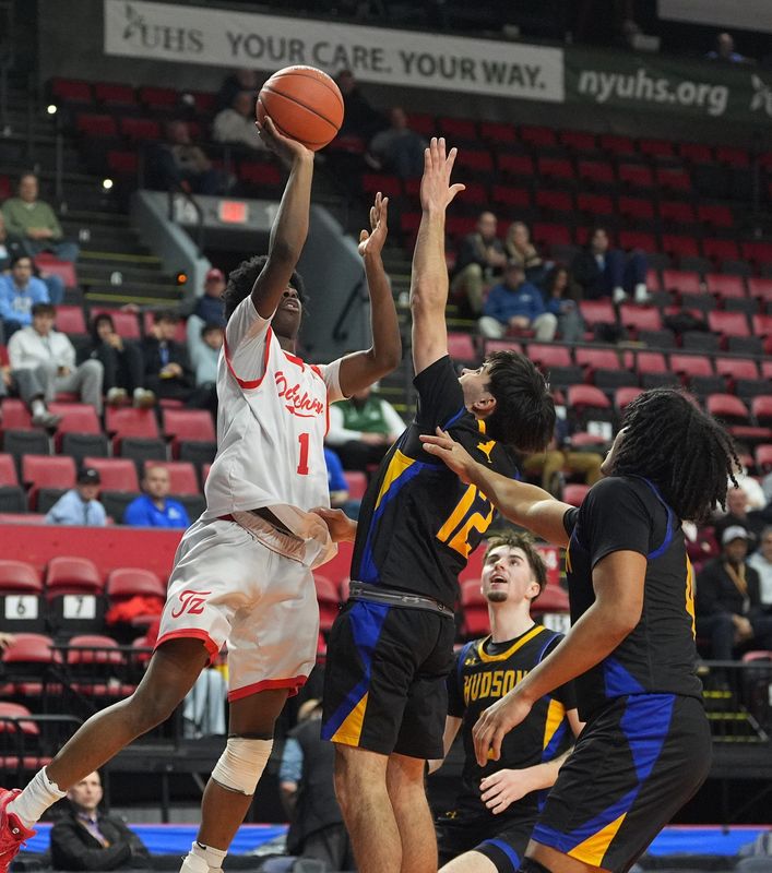 Tappan Zee's Isaiah Leveille (1) goes over Hudson's Eli Conte (12) during the Class A boys basketball NYSPHSAA semifinal game at Visions Veterans Memorial Arena in Binghamton on Thursday, March 19, 2026.