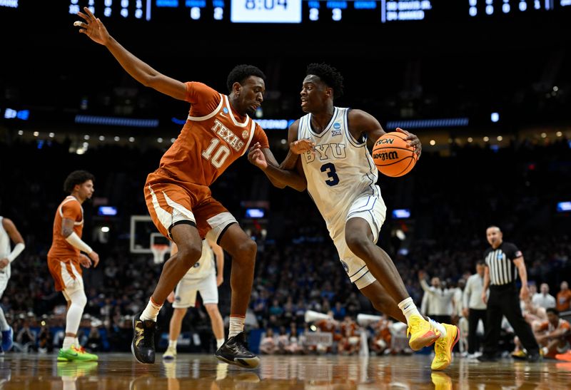 Mar 19, 2026; Portland, OR, USA; BYU Cougars forward AJ Dybantsa (3) drives against Texas Longhorns forward Nic Codie (10) in the second half during a first round game of the men's 2026 NCAA Tournament at Moda Center. Mandatory Credit: Troy Wayrynen-Imagn Images