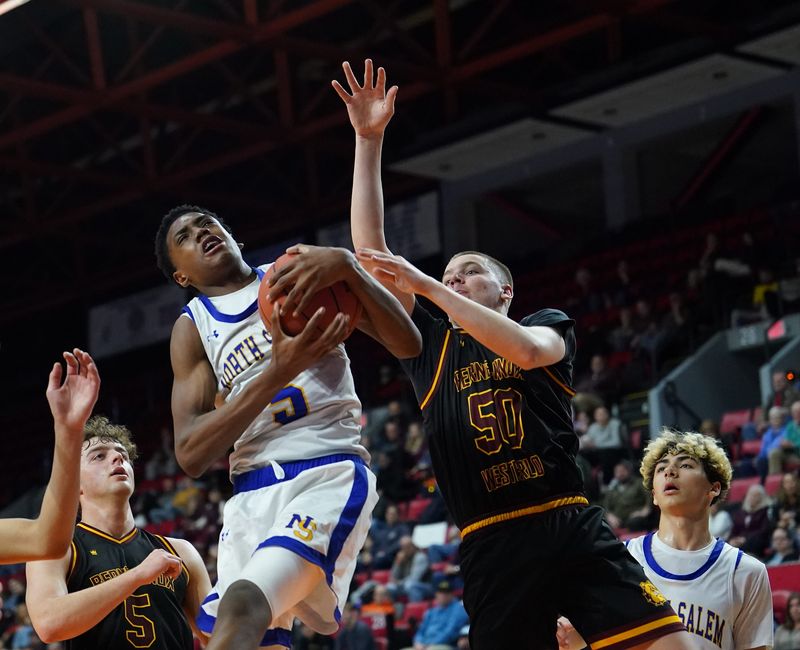 North Salem's Bryce Bryant (5) drives past Berne-Knox-Westerlo's Chris Dwyer (50) during the NYSPHSAA Class C boys basketball semifinal at Visions Veterans Memorial Arena in Binghamton on Saturday, March 21, 2026.