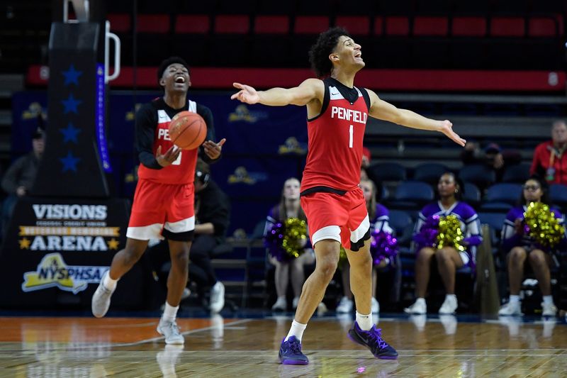 Penfield's Jackson Green, right, and Aaron Hardaway (5) celebrate their win during the NYSPHSAA Boys Basketball Championships Class AA final Saturday, March 21, 2026, in Binghamton, N.Y. Penfield won the Class AA title with a 62-54 win over Amsterdam (II).