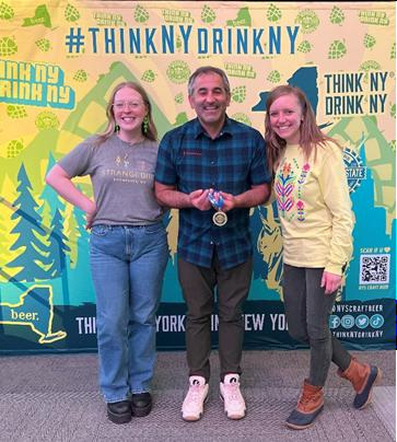 Strangebird's Ellyn Gooch, Micah Krichinsky and Amanda Richardson show off their gold medal at the New York State Craft Beer Competition. Strangebird took home five medals in all.