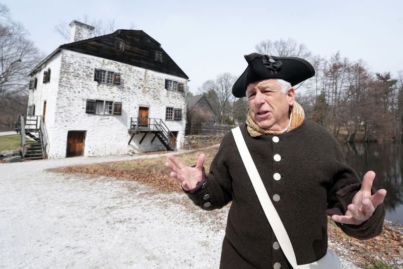With the manor house behind him, Museum Educator Andrew Halpern gives a tour of Philipsburg Manor, a historical site in Sleepy Hollow March 20, 2026. In the 18th century, Philipsburg Manor was a milling, trading and farming center with 23 enslaved people working and living at the site.