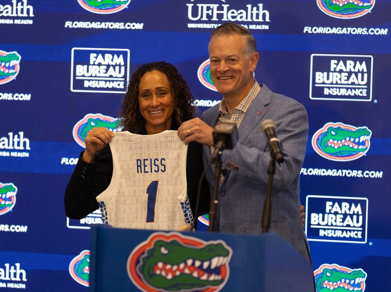 New Womens basketball coach Tammi Reiss, left, poses with University Athletic Director Scott Stricklin for a photo with Florida athletic direct speaks during a press conference after spring practice at Sanders Practice Fields in Gainesville, FL on Tuesday, March 24, 2026. [Alan Youngblood/Gainesville Sun]