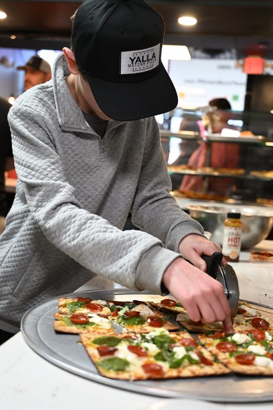 Armonk student Hudson Greenstein, 12, making his famous Yalla Matza pizza.