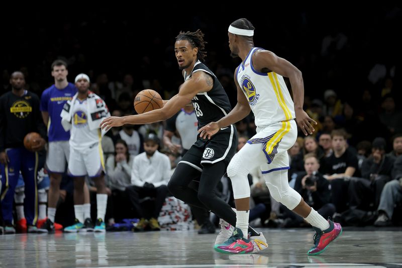 Dec 29, 2025; Brooklyn, New York, USA; Brooklyn Nets center Nic Claxton (33) brings the ball up court against Golden State Warriors forward Jimmy Butler III (10) during the fourth quarter at Barclays Center. Mandatory Credit: Brad Penner-Imagn Images