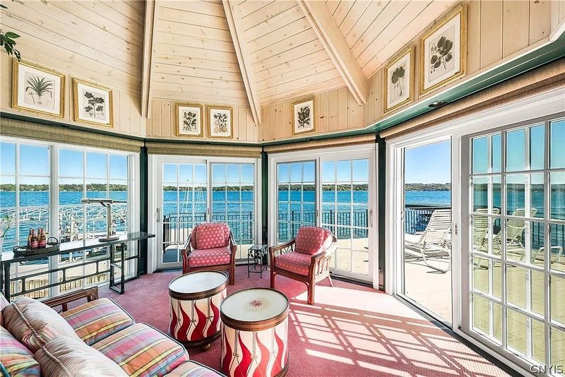 The lake pavilion interior includes a refrigerator, a sink, a seating area, a powder room and a deck.