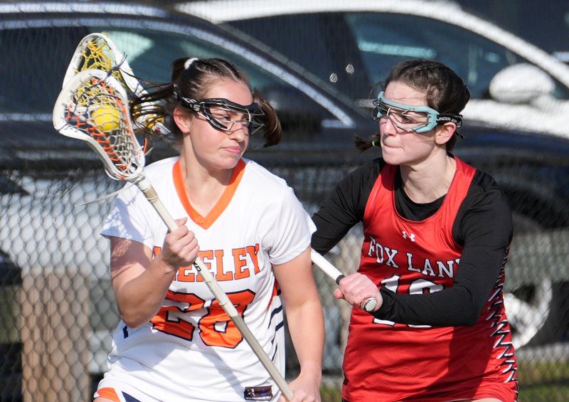 Greeley’s Samantha Rose (28) tries to get around Fox Lane’s Isabel Valenzuela (10) during girls lacrosse action at Horace Greeley High School in Chappaqua March 25, 2026. Fox Lane defeated Horace Greeley 6-5 in 4 overtimes