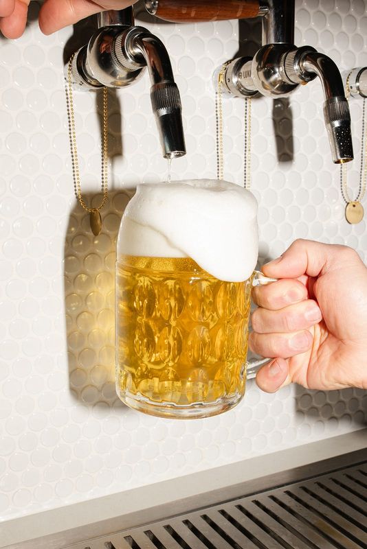 The head overflows as a light lager is poured at the Lower Lake Brewery Tap Room in Hamilton.