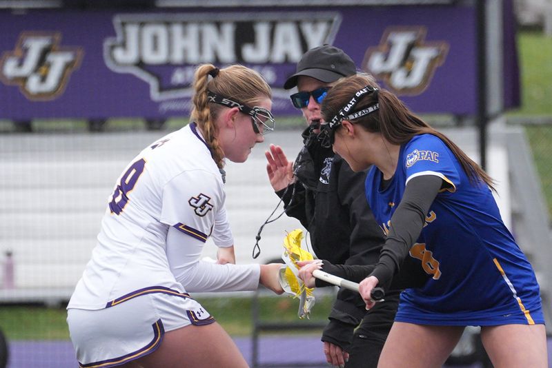 John Jay-Cross River's Dillon Hall and Mahopac's Bella Gangemi prepare for the draw during an April 2, 2026 girls lacrosse game.