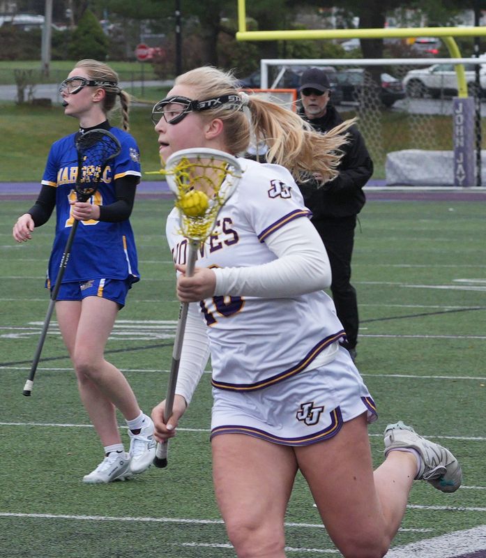 John Jay-Cross River's Fin Degl sprints up the sideline against Mahopac during an April 2, 2026 girls lacrosse game.
