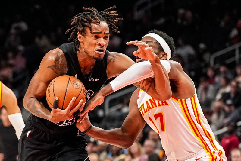 Mar 12, 2026; Atlanta, Georgia, USA; Brooklyn Nets center Nic Claxton (33) tries to battle past Atlanta Hawks forward Onyeka Okongwu (17) during the first half at State Farm Arena. Mandatory Credit: Dale Zanine-Imagn Images