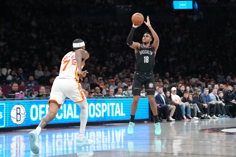Apr 3, 2026; Brooklyn, New York, USA; Brooklyn Nets guard Malachi Smith (18) shoots a three-point jump shot over Atlanta Hawks guard Nickell Alexander-Walker (7) during the first half at Barclays Center. Mandatory Credit: Gregory Fisher-Imagn Images