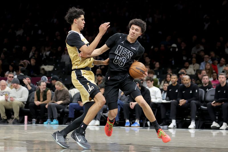 Feb 7, 2026; Brooklyn, New York, USA; Brooklyn Nets guard Nolan Traore (88) drives to the basket against Washington Wizards guard Will Riley (27) during the third quarter at Barclays Center. Mandatory Credit: Brad Penner-Imagn Images