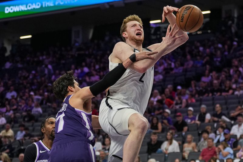 Mar 22, 2026; Sacramento, California, USA; Brooklyn Nets forward Danny Wolf (2) is fouled by Sacramento Kings forward Doug McDermott (7) during the second quarter at Golden 1 Center. Mandatory Credit: Justine Willard-Imagn Images