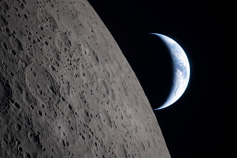 A view of Earth, partially hidden by the Moon, photographed through the Orion spacecraft window at 6:40 p.m. EDT April 6, 2026, just four minutes before the Orion spacecraft and its crew went behind the moon and lost contact with Earth for 40 minutes before emerging on the other side during the Artemis II crew’s flyby of the moon.