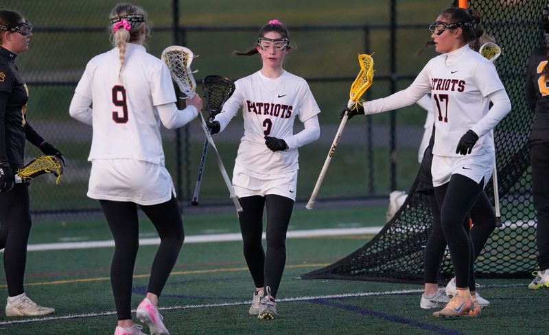 Penfield’s Alexa Corcoran (2) celebrates her goal with teammates Peyton Rothfuss and Whitney Reynolds after her score put Penfield up 4-2 in the second quarter during their Section V girls lacrosse game Tuesday, April 7, 2026 at Penfield High School.