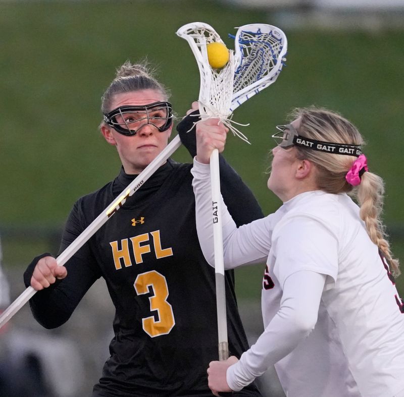 HF-L’s Shaye Angelo and Penfield’s Peyton Rothfuss battle for control of the ball during their Section V girls lacrosse game Tuesday, April 7, 2026 at Penfield High School.