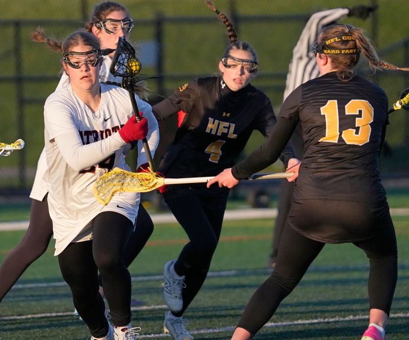 Penfield’s Olivia Reed grabs a loose ball and races it up field past HF-L’s Mackinley Buckley during their Section V girls lacrosse game Tuesday, April 7, 2026 at Penfield High School.