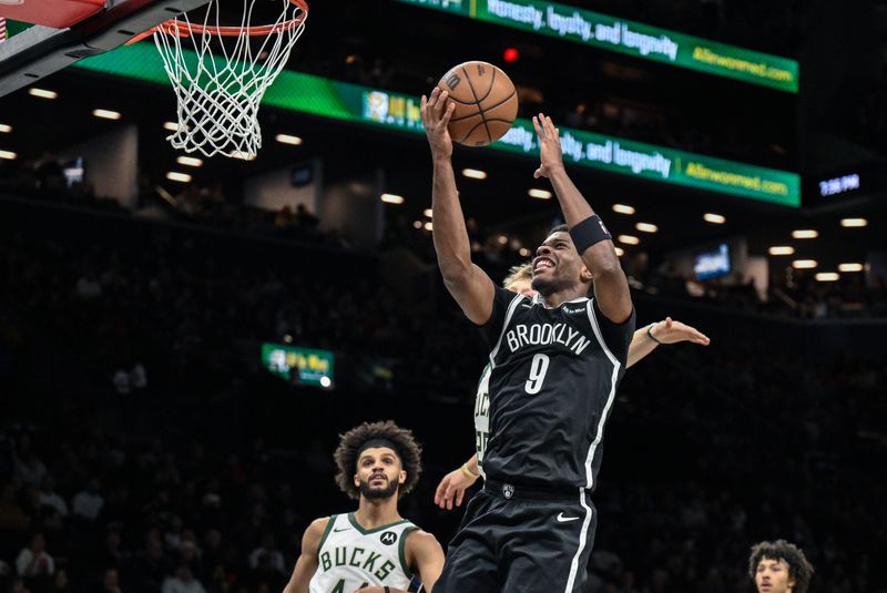 Apr 7, 2026; Brooklyn, New York, USA; Brooklyn Nets forward E.J. Liddell (9) drives past Milwaukee Bucks guard AJ Green (20) during the first half at Barclays Center. Mandatory Credit: John Jones-Imagn Images