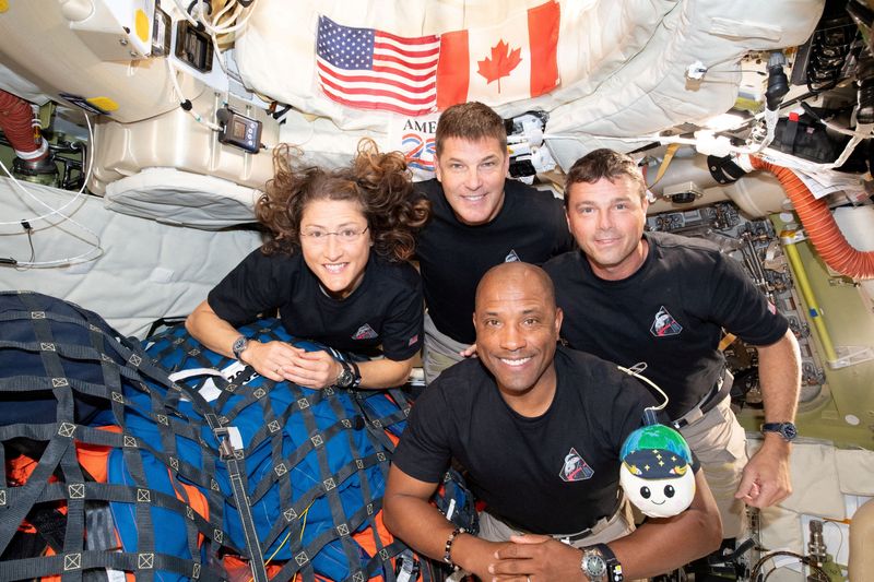 The NASA Artemis II crew are, from left, mission specialist Christina Koch, mission specialist Jeremy Hansen, pilot Victor Glover and commander Reid Wiseman inside the Orion spacecraft on their way home after a flyby of the far side of the noon on April 6, 2026.