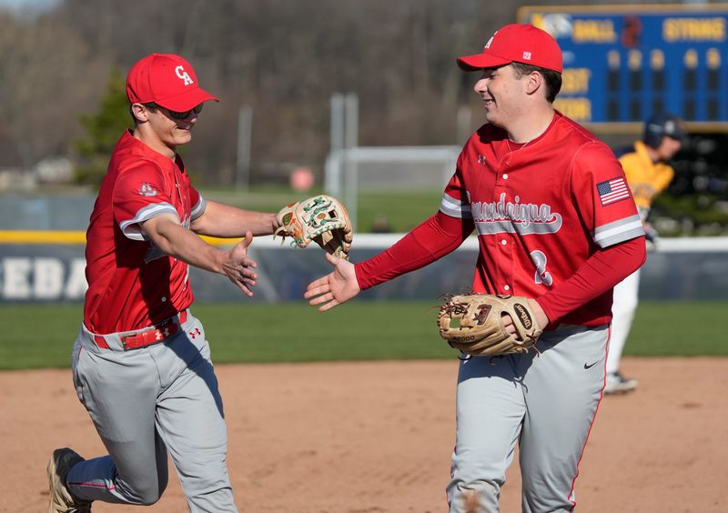 Canandaigua third baseman Chase Senn celebrates with teammate shortstop Austin Kierst after his nice stop and put out of Victor’s Brayden Ricigliano on a hard hit grounder down the line to end the first inning during their Section V baseball game Wednesday, April 8, 2026 at Victor High School.